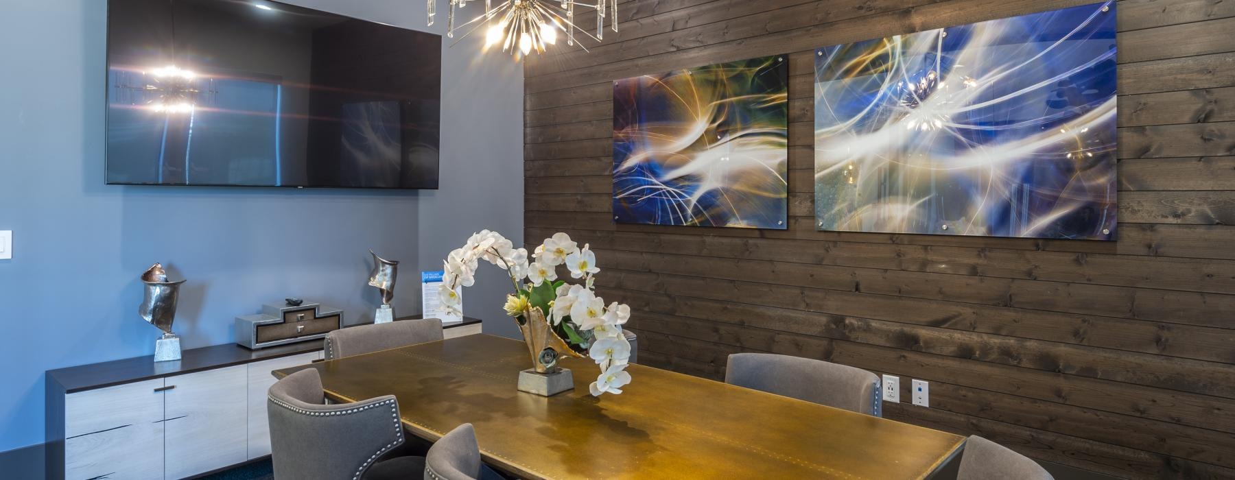 a dining room table with a chandelier above it