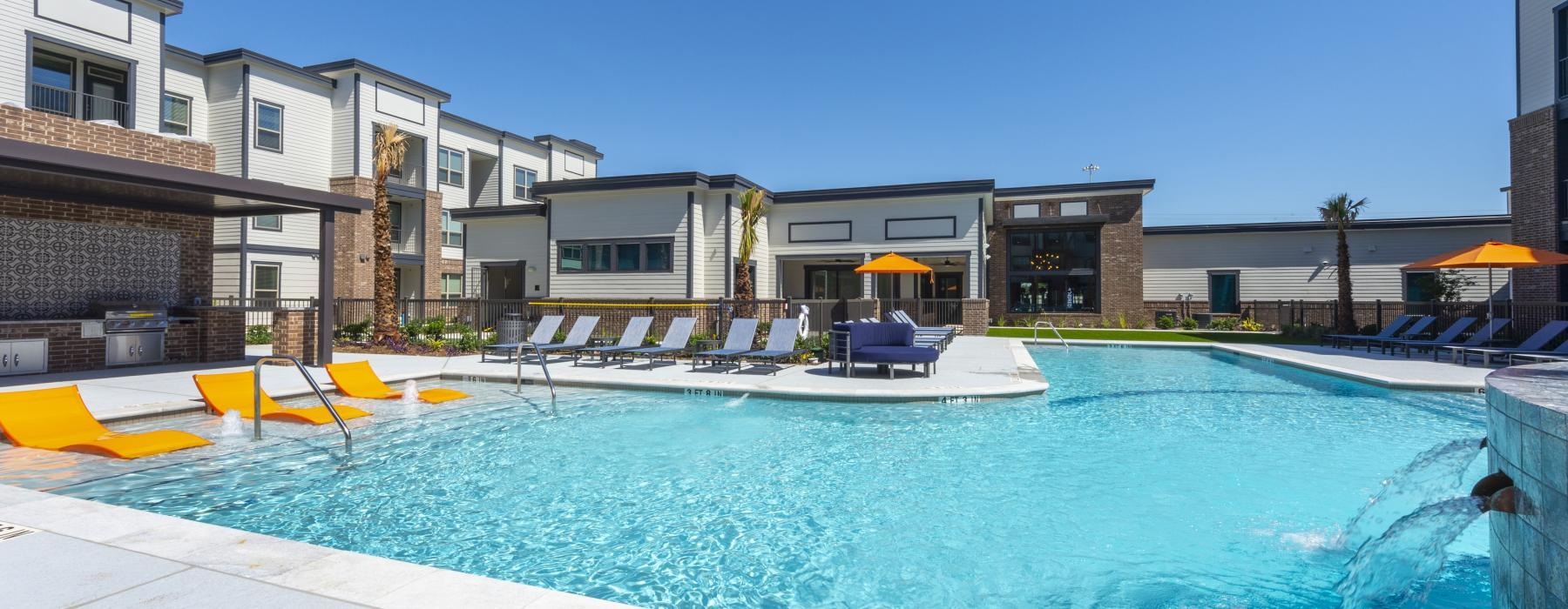 a swimming pool with a lounge chair and umbrella